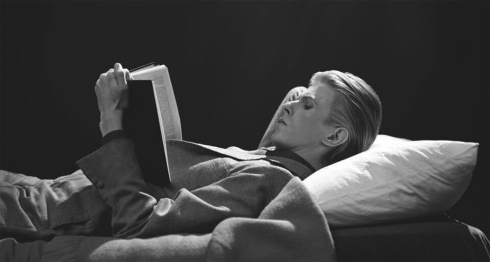 David Bowie reading a book, 1976